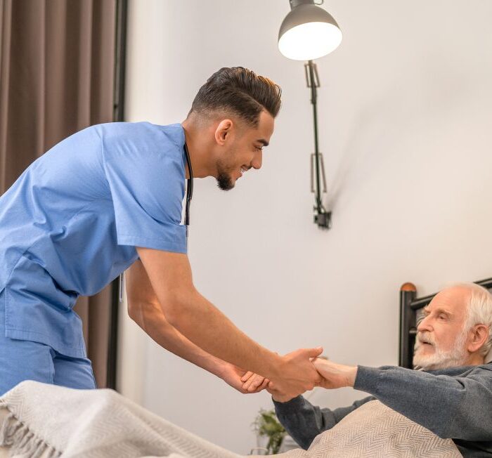 male nurse taking care of a senior