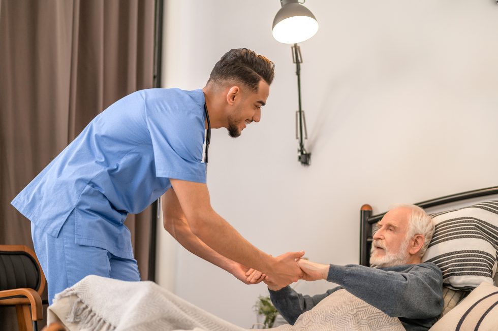 male nurse taking care of a senior